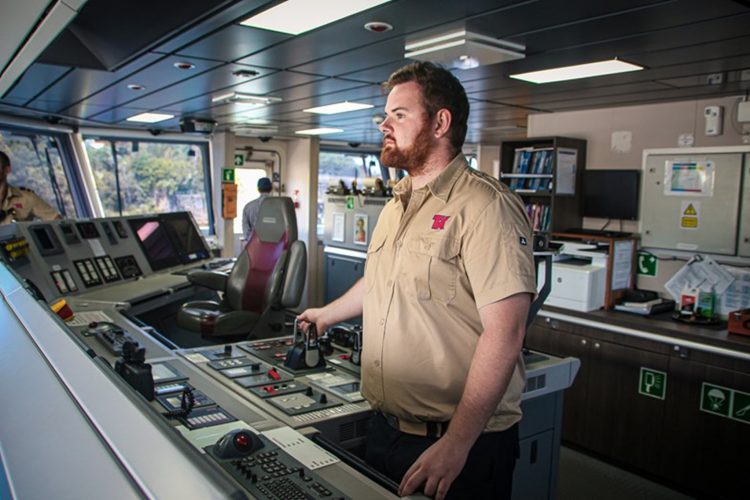 Port Authority cadet Sean at the helm of the MV Sycamore