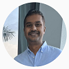 George Mathew in a blue collared shirt