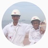 father and son in coveralls and helmet