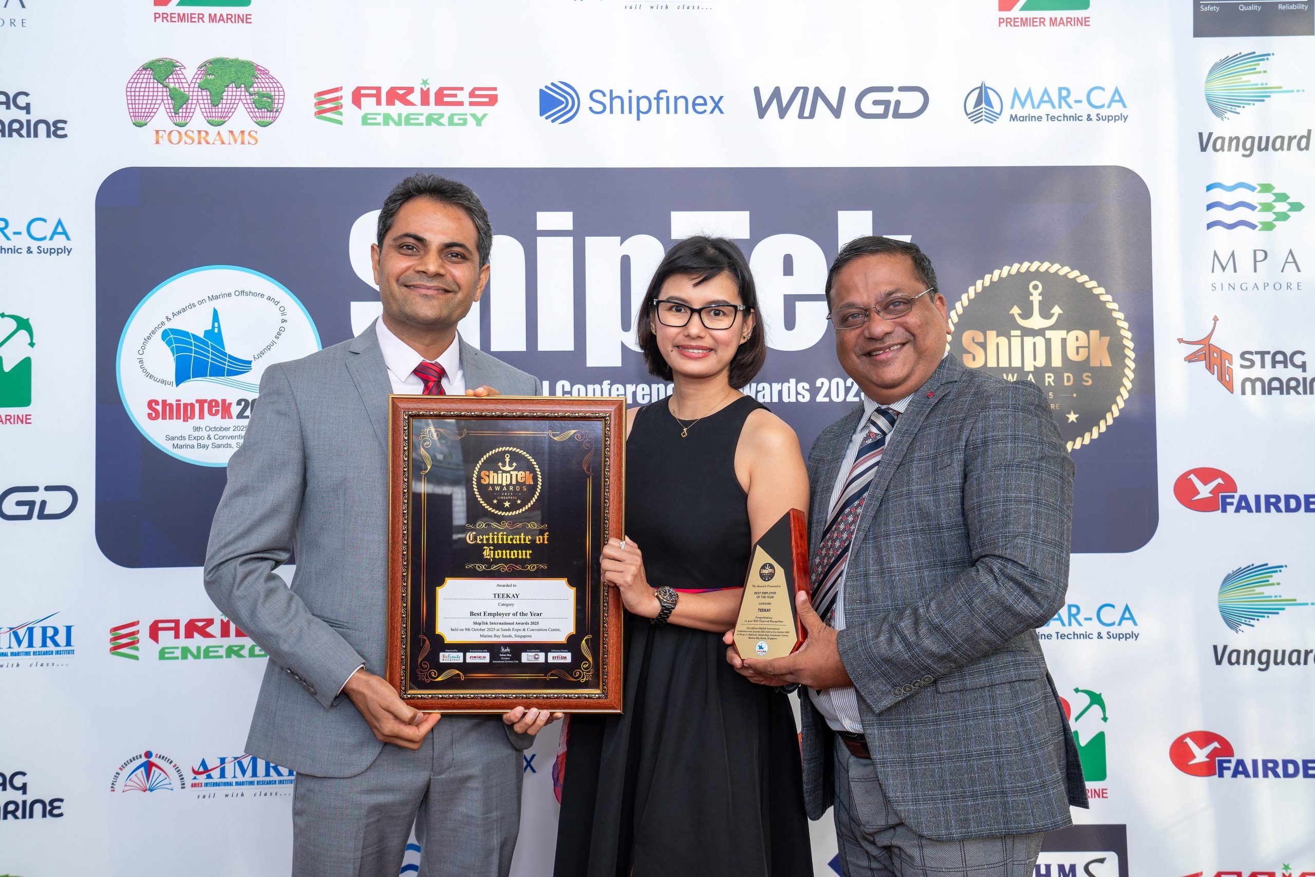 Our Teekay representatives posing with the award and plaque